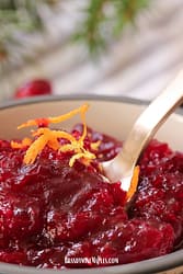 Cranberry sauce with an orange zest garnish.