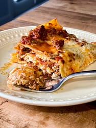 A piece of lasagna on a yellow plate