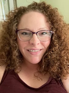 Red headed woman wearing a red tank top